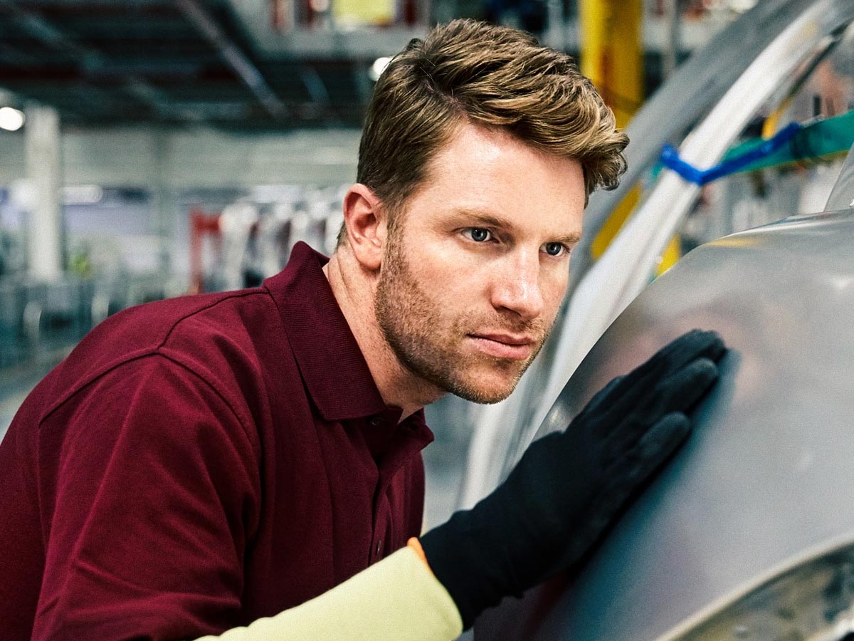 nationwide overspray cleaned by hand - a guy inspecting car's surface