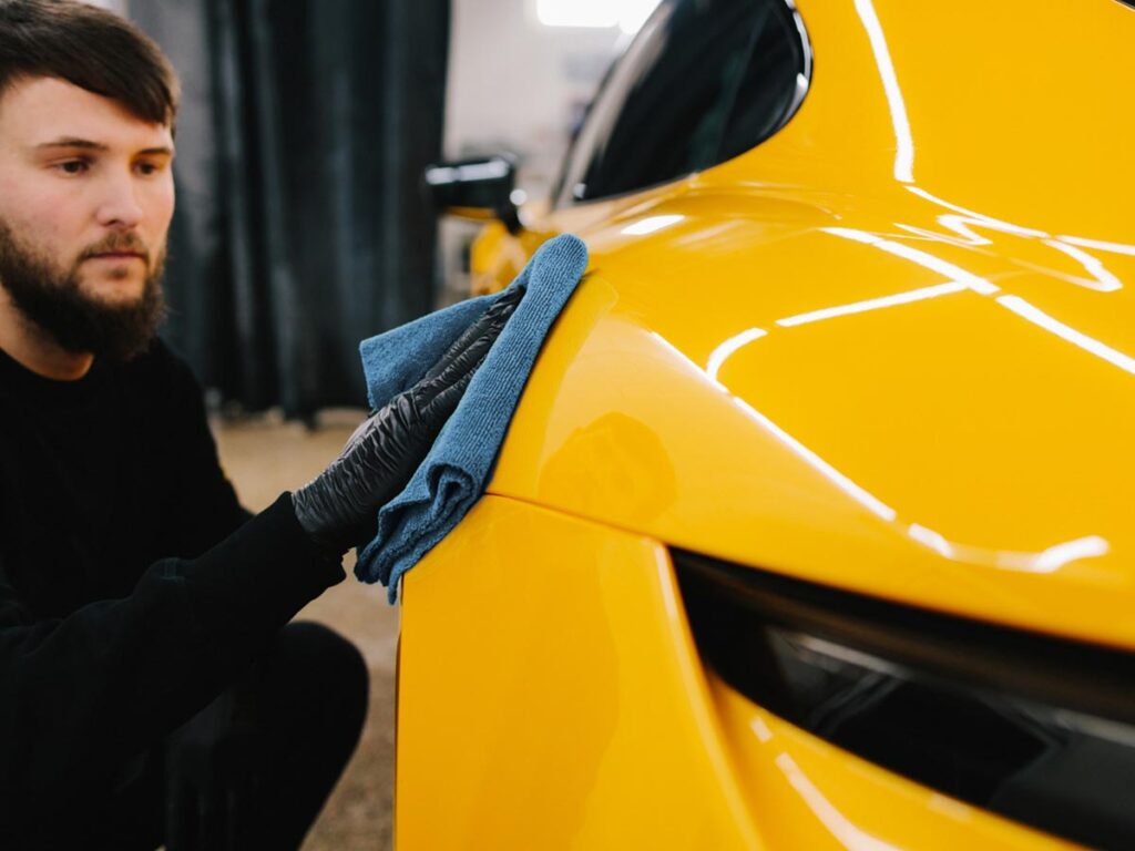 nationwide professional overspray removal services - service member polishing a car